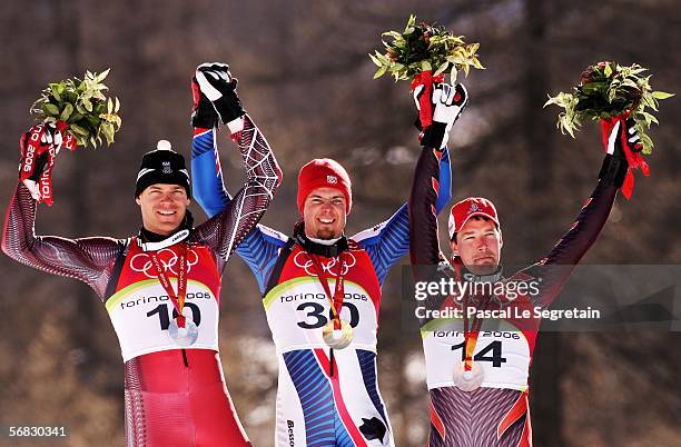 Winners Michael Walchhofer of Austria, silver, Antoine Deneriaz of France, gold and Bruno Kernen of Switzerland, bronze, pose together after the...