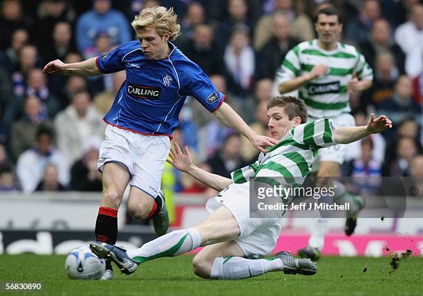 Chris Burke of Rangers is tackled by Mark Wilson of Celtic during the Scottish Premier League match between Rangers and Celtic at Ibrox Stadium on...