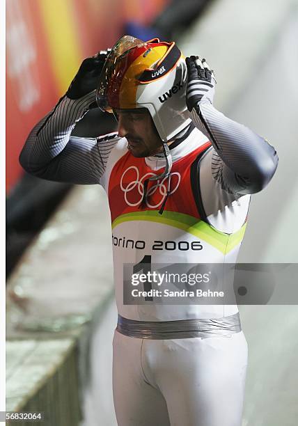 Georg Hackl of Germany removes his helmet after his final run in the Mens Luge Single Final on Day 2 of the 2006 Turin Winter Olympic Games on...