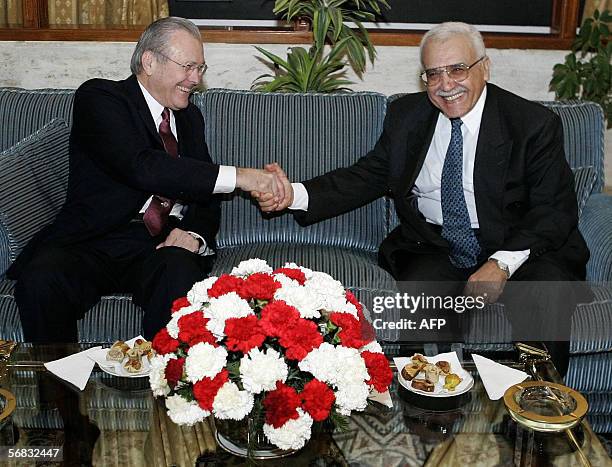 Secretary of Defense Donald Rumsfeld shakes hands with his Algerian counterpart Abdelmalek Guenaizia as they meet at the Defense Ministry in Algiers...