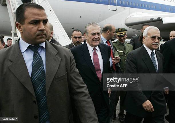 Secretary of Defense Donald Rumsfeld is escorted from his plane by his Algerian counterpart Abdelmalek Guenaizia as Rumsfeld arrives for meetings in...
