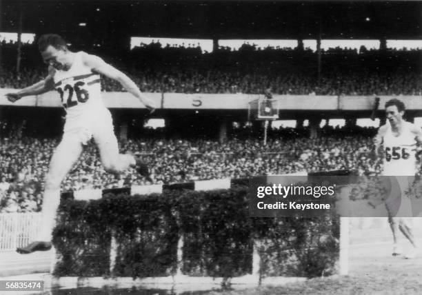 Great Britain's Chris Brasher clears the water jump in the last lap of the 3,000 metre steeplechase at the 1956 Olympic Games in Melbourne, 29th...
