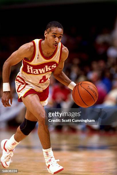 Spud Webb of the Atlanta Hawks brings the ball upcourt against the Denver Nuggets during an NBA game at the Omni circa 1986 in Atlanta, Georgia. NOTE...
