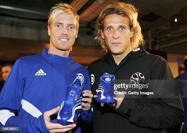 Christian Wilhelmsson poses with Diego Forlan and their new +F50 Tunit shoes during the Major adidas +F50 Tunit Launch Event on February 13, 2006 in...