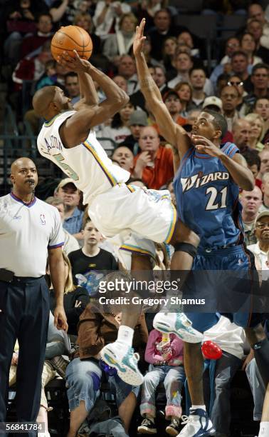 Speedy Claxton of the New Orleans/Oklahoma City Hornets tries to get a shot off over Donell Taylor of the Washington Wizards during NBA action...