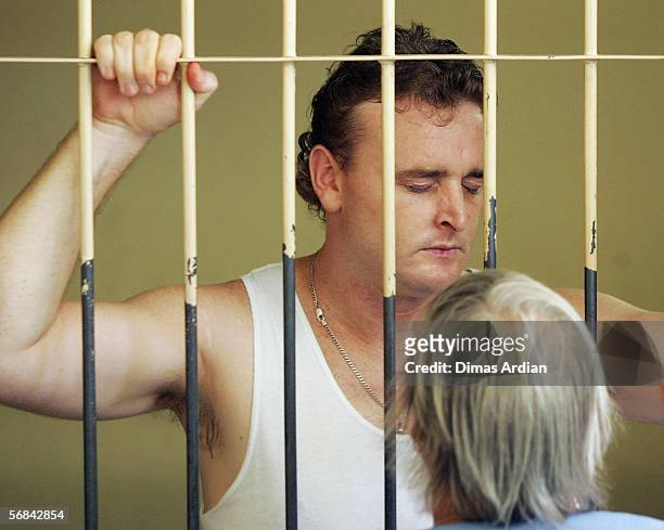 Martin Stephens talks to his mother from inside a court holding cell February 14, 2006 in Denpasar, on the Indonesian resort island of Bali....