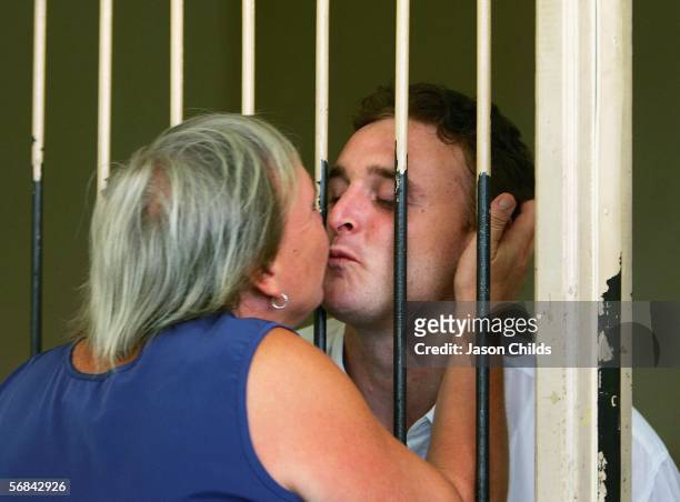 Martin Stephens kisses his mother Michelle Stephens from his holding cell after his sentencing at Denpasar Court February 14, 2006 in Denpasar, on...