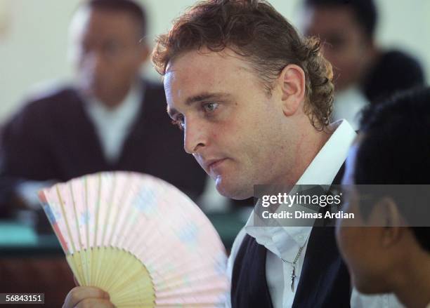 Martin Stephens fans himself during his sentencing trial in the Denpasar Couthouse February 14, 2006 in Denpasar, on the Indonesian resort island of...