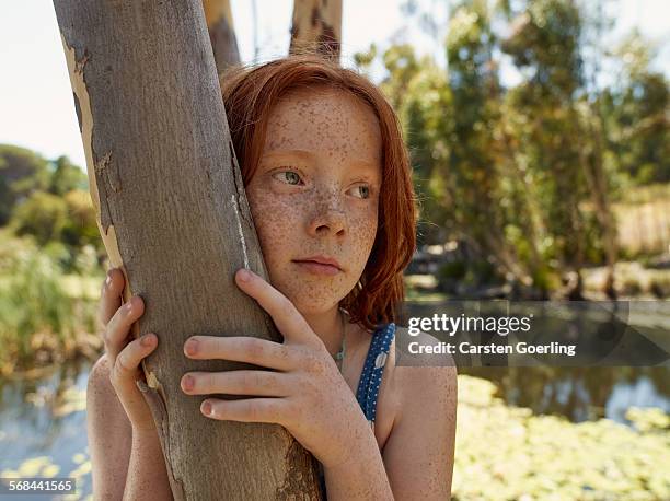 girl leaning on a tree - freckle girl stock pictures, royalty-free photos & images