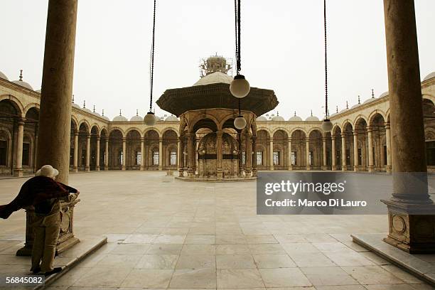 Tourist stands in the court yard of the Mosque of Mohammed Ali or Alabaster Mosque in the Citadel on February 8, 2006 in Islamic Cairo, Egypt. The...