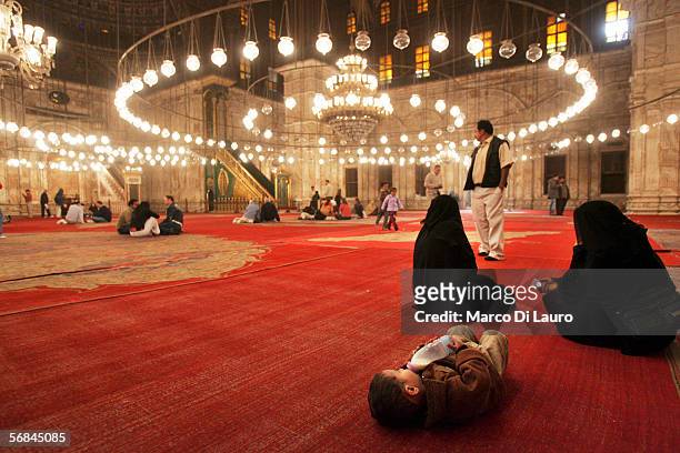 Two veiled woman and a baby seat inside the Mosque of Mohammed Ali or Alabaster Mosque in the Citadel on February 8, 2006 in Islamic Cairo, Egypt....
