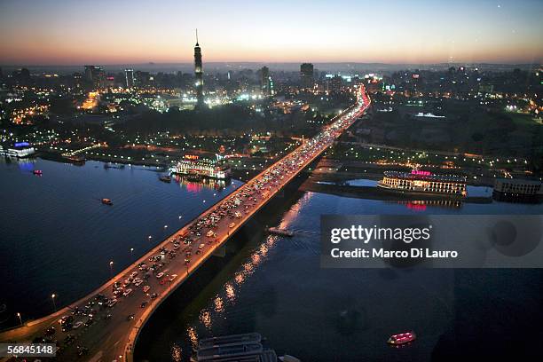 Cars drive on a bridge crossing the Nile River on February 9, 2006 in Central Cairo, Egypt. Cairo is still the heart of Egypt and is allegorically...