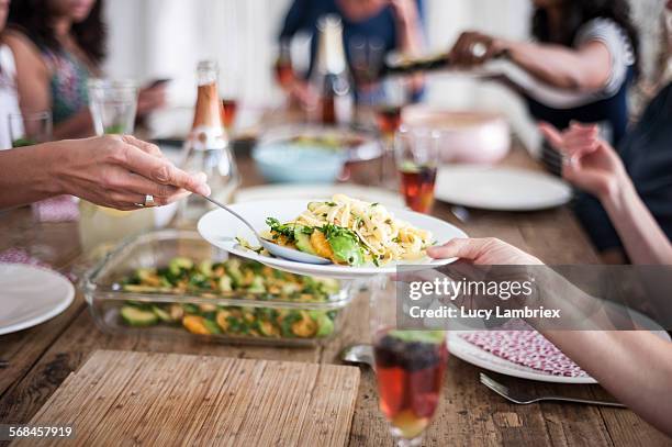 serving food - group of people eating dinner stock pictures, royalty-free photos & images