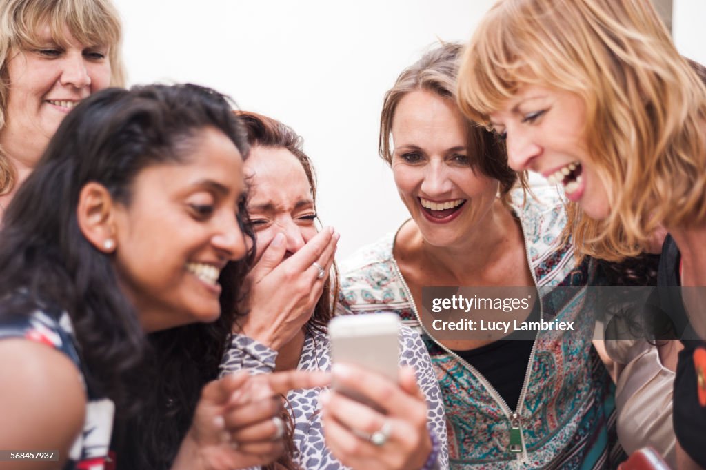 Women looking at the smartphone photos they took