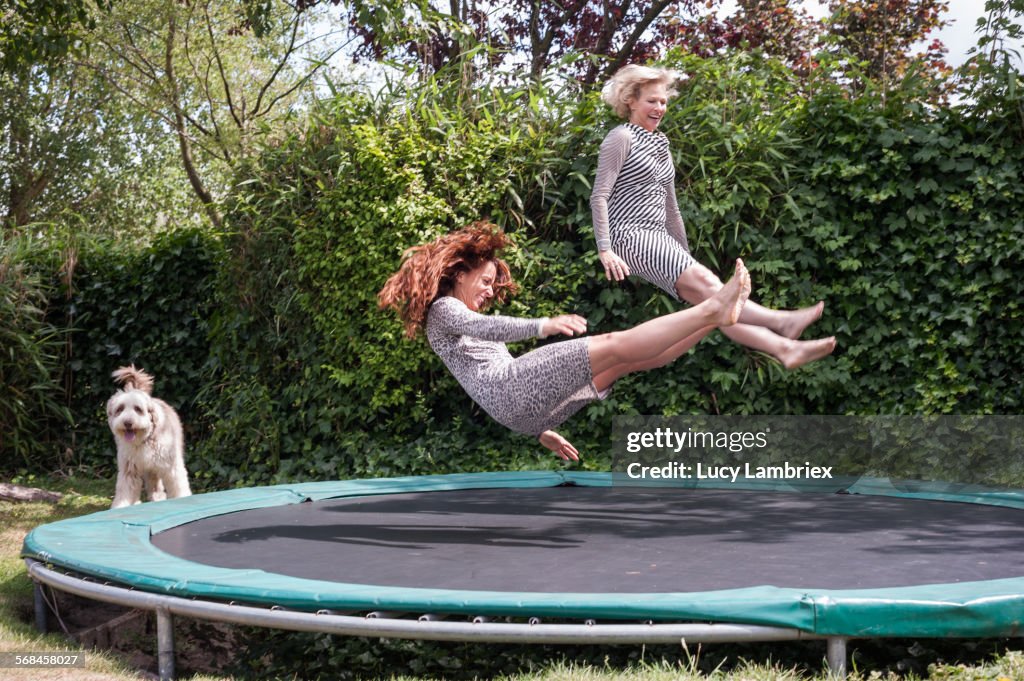 Two women playing on trampoline