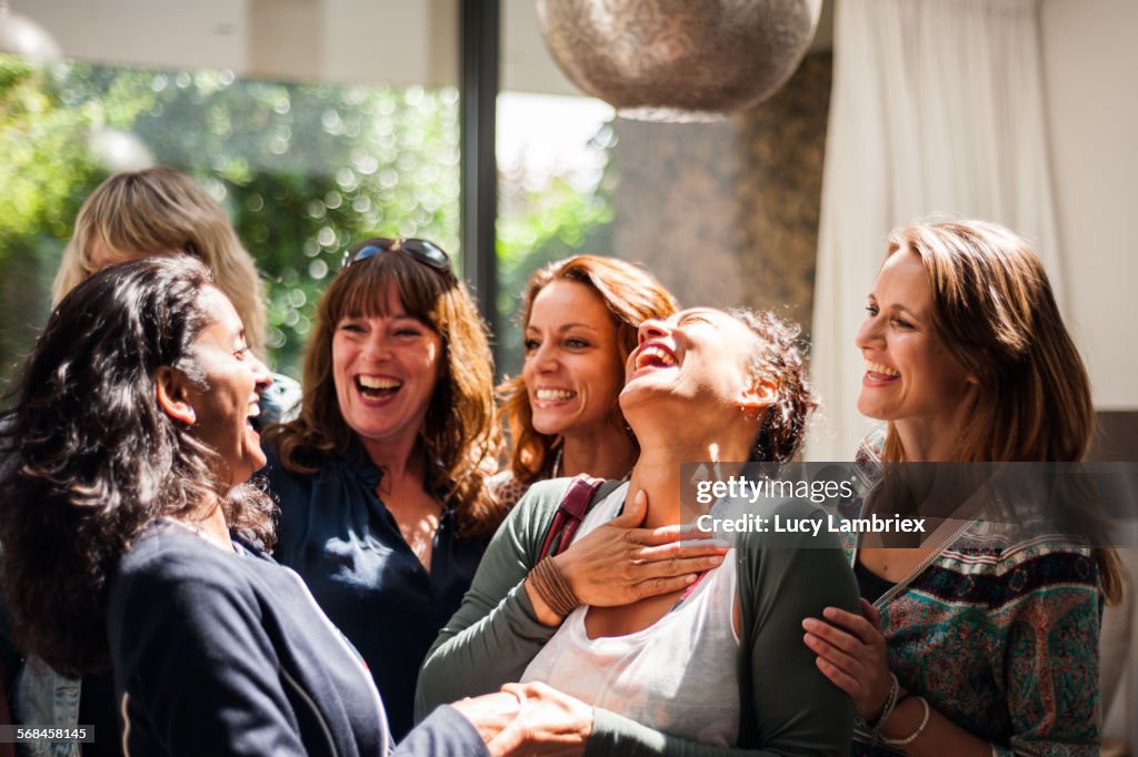 Women at reunion greeting and smiling