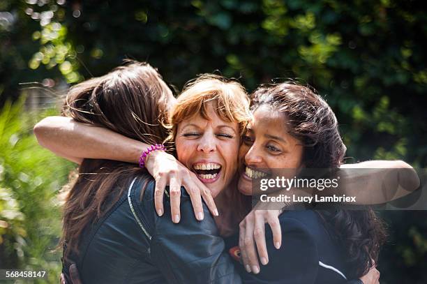 women greeting one another - gruppe stock-fotos und bilder