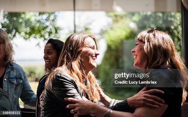 women greeting one another - reunions stock pictures, royalty-free photos & images