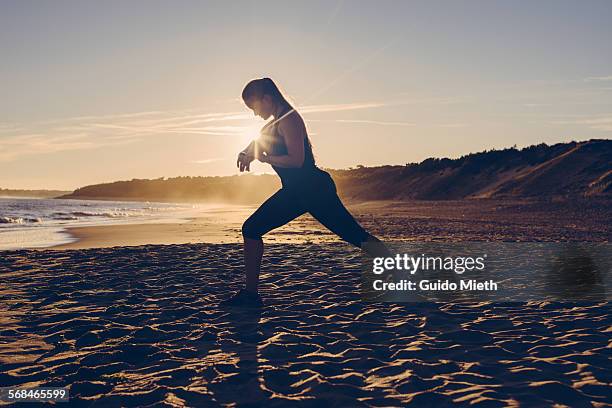 woman checking smartwatch at beach. - longeville sur mer stock pictures, royalty-free photos & images