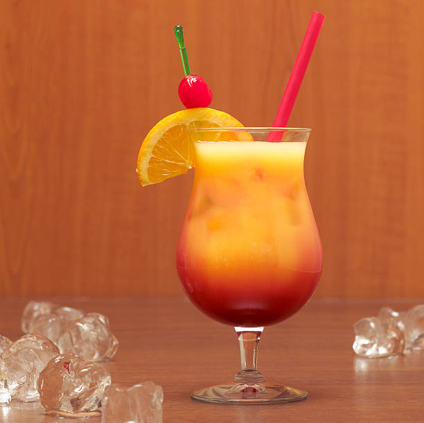 tequila with orange garnish, close-up - orange cocktail stock pictures, royalty-free photos & images