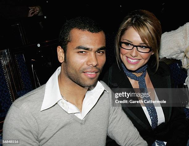 England football player Ashley Cole and singer Cheryl Tweedy of Girls Aloud attend the Julien Macdonald fashion show as part of London Fashion Week...