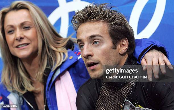 France's Frederic Dambier is seen with his coach Annick Dumont in the "Kiss and Cry" zone during the men's short program of the Figure skating...