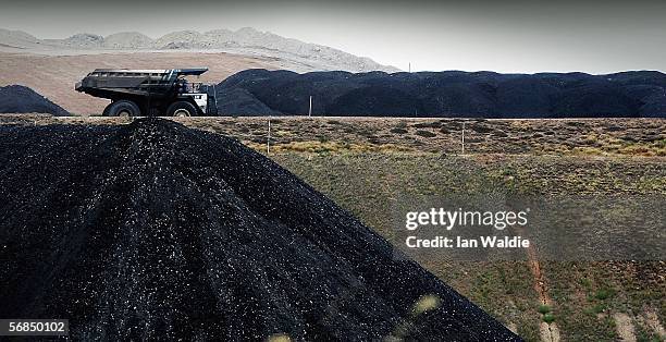 Coal truck passes a huge pile of coal at BHP Billiton's Mt Arthur coal mine February 15, 2006 in Muswellbrook, Australia. BHP today posted the...