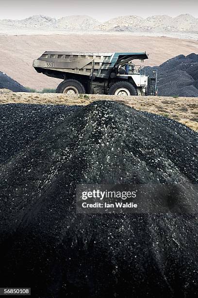 Coal truck passes a huge pile of coal at BHP Billiton's Mt Arthur coal mine February 15, 2006 in Muswellbrook, Australia. BHP today posted the...