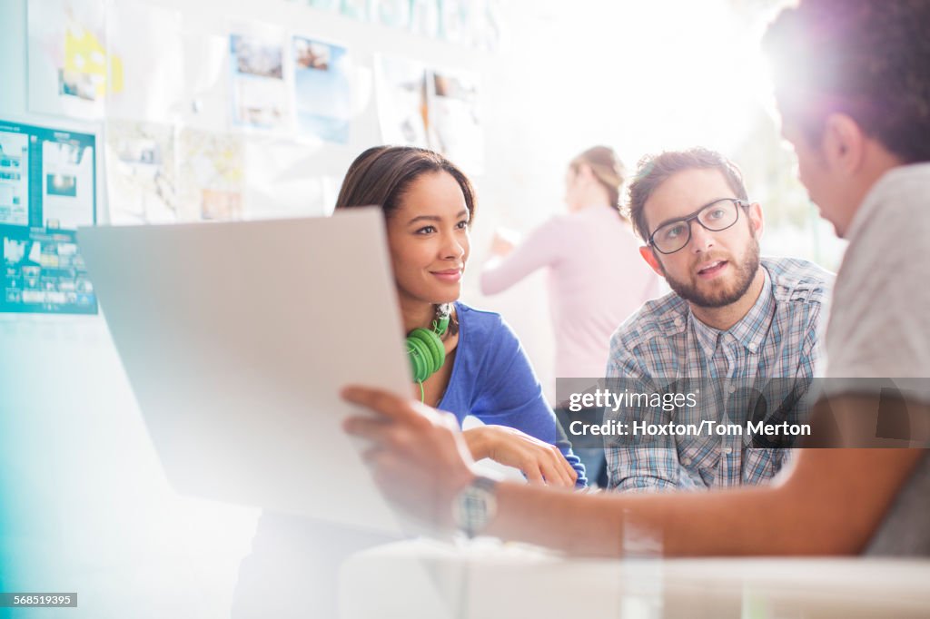 Creative business people discussing paperwork in office