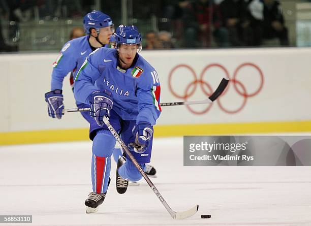 Guilio Scandella of Italy brings the puck up the ice during the men's ice hockey Preliminary Round Group A match against Canada on Day 5 of the Turin...