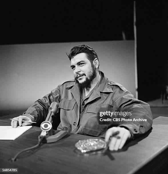 Argentinian-born Marxist revolutionary Ernesto Che Guevara , Cuban Minister of Industry, dressed in military fatigues, smokes a cigar and appears on...