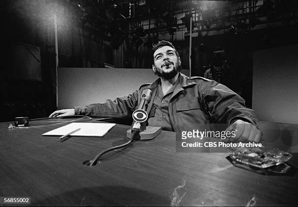 Argentinian-born Marxist revolutionary Ernesto Che Guevara , Cuban Minister of Industry, dressed in military fatigues and smoking a cigar, reclines...