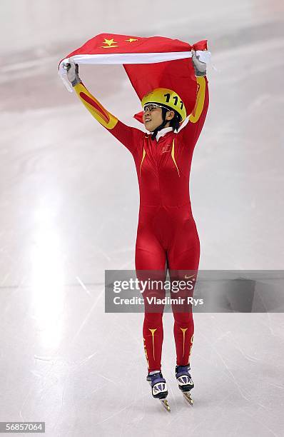 Meng Wang of China waves the flag of China after winning gold in the women's 500m Short Track Speed Skating Final during Day 5 of the Turin 2006...