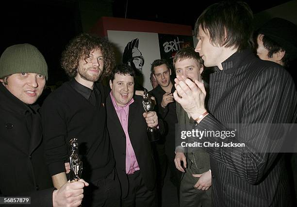 Simon Rix, Ricky Wilson, Nick Hodgson and Andrew White of The Kaiser Chiefs and comedian Peter Kay pose in the Awards Room with the award for Best...