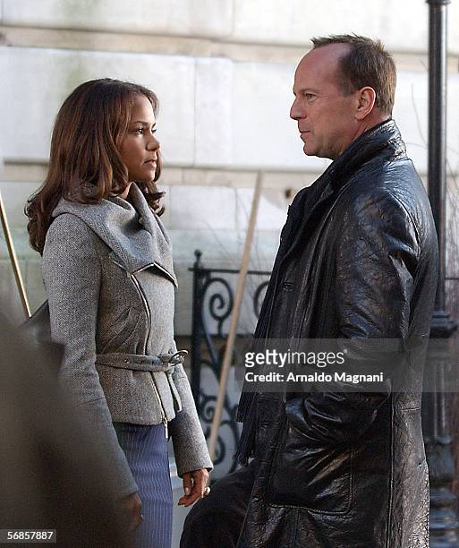 Bruce Willis and Halle Berry talk on the set of the new movie "Perfect Stranger" filming on Broadway on February 15, 2006 in New York City.