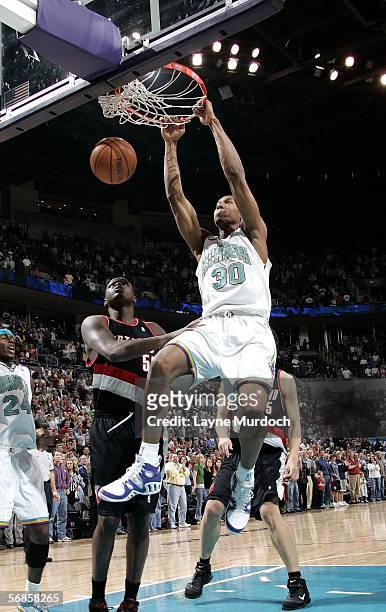 David West of the New Orleans/Oklahoma City Hornets dunks against Zach Randolph the Portland Trail Blazers on February 15, 2006 at the Ford Center in...