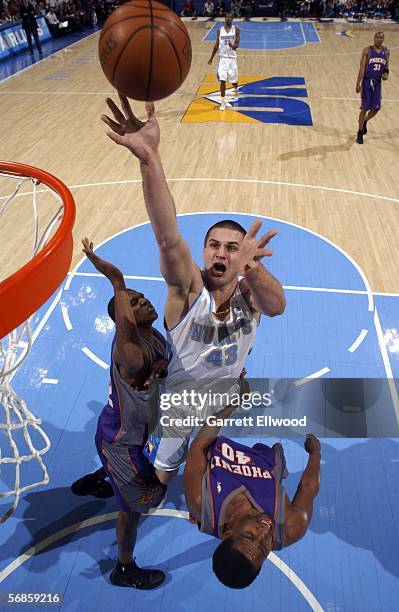 Linus Kleiza of the Denver Nuggets goes to the basket against Kurt Thomas of the Phoenix Suns on February 15, 2006 at the Pepsi Center in Denver,...