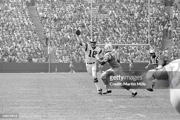 Quarterback Roman Gabriel of the Los Angeles Rams attempts to throw a pass over defensive end Joe Owens of the San Diego Chargers during a game circa...