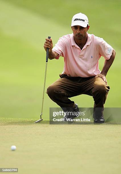 Jyoti Randhawa of India lines up a putt on the 11th green during the first round of the Maybank Malaysian Open 2006 at Kuala Lumpur Golf and Country...