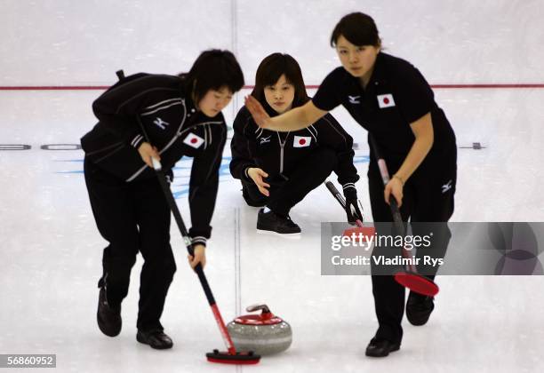 Yumie Hayashi , Moe Meguro and Mari Motohashi of Japan compete during the preliminary round of the women's curling between Japan and Denmark during...