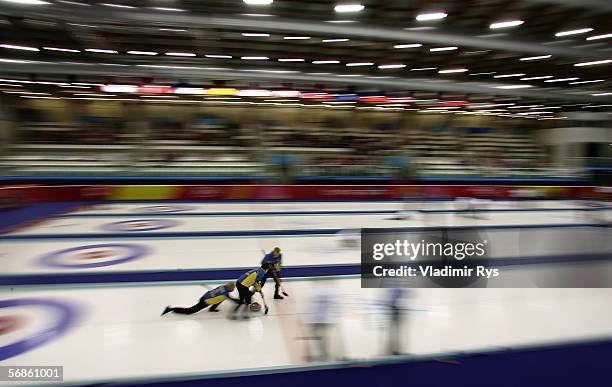 Eva Lund, Cathrine Lindahl and Anna Svaerd of Sweden compete during the preliminary round of the women's curling between Sweden and Italy during Day...