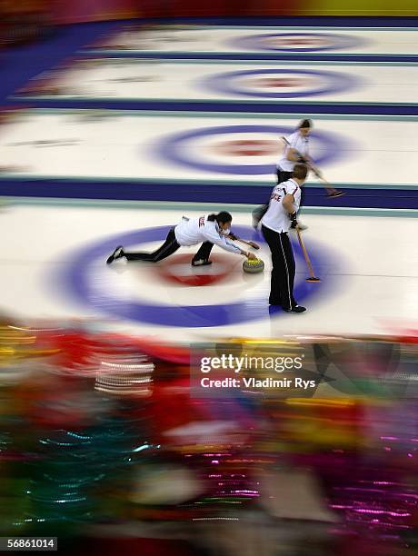 Valeria Spaelty, Michaela Moser and Binia Beeli of Switzerland compete during the preliminary round of the women's curling between Canada and...