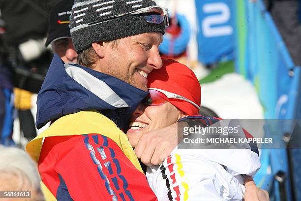 Cesana San Sicario, ITALY: Germany's double Olympic champion Kati Wilhelm is consoled by her boyfriend Andreas Emslander after she came in seventh...