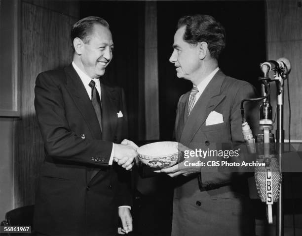 American broadcast network executive, president of CBS radio, and founder of CBS television William S. Paley shakes hands with American writer,...