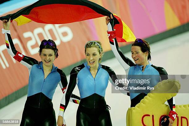 Claudia Pechstein, Anni Fiesinger and Daniela Anschuetz Thoms of Germany celebrate winning the Gold Medal against Canada in women's speed skating...