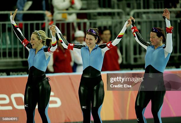 Claudia Pechstein, Anni Fiesinger and Daniela Anschuetz Thoms of Germany celebrate winning the Gold Medal against Canada in women's speed skating...