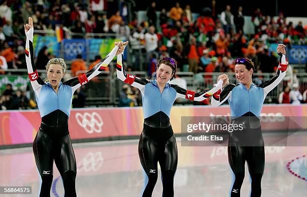Claudia Pechstein, Anni Fiesinger and Daniela Anschuetz Thoms of Germany celebrate winning the Gold Medal against Canada in women's speed skating...