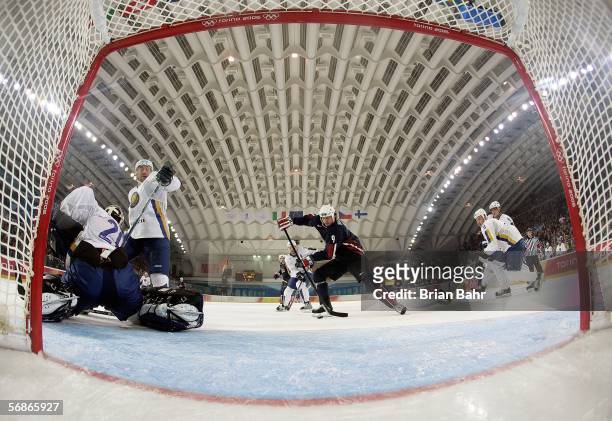Mike Modano of the United States shoots and scores USA's fourth goal over goalkeeper Vitaliy Kolesnik of Kazakhstan during the third period of the...