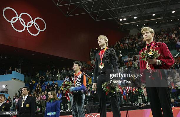 Stephane Lambiel of Switzerland wins the silver medal, Evgeni Plushenko of Russia wins the gold medal and Jeffrey Buttle of Canada wins the bronze...