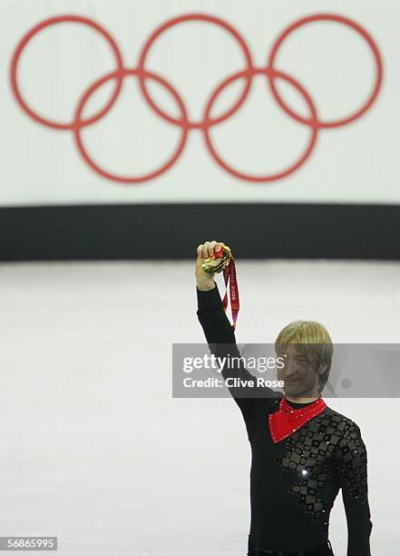 Evgeni Plushenko of Russia holds up his medal after winning the gold medal in Men's Figure Skating following the Men's Free Skate Program Final...